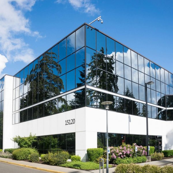 pexels-photo-269077-269077 Contemporary office building in Redmond with reflective glass and lush greenery, captured on a sunny day.