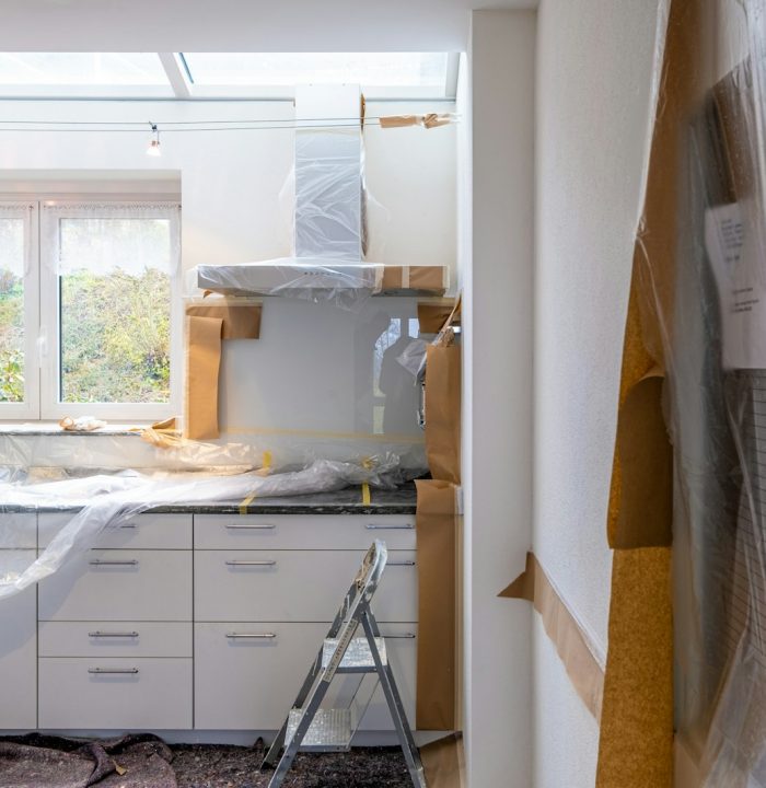 Photo by immo RENOVATION white wooden cabinet near window